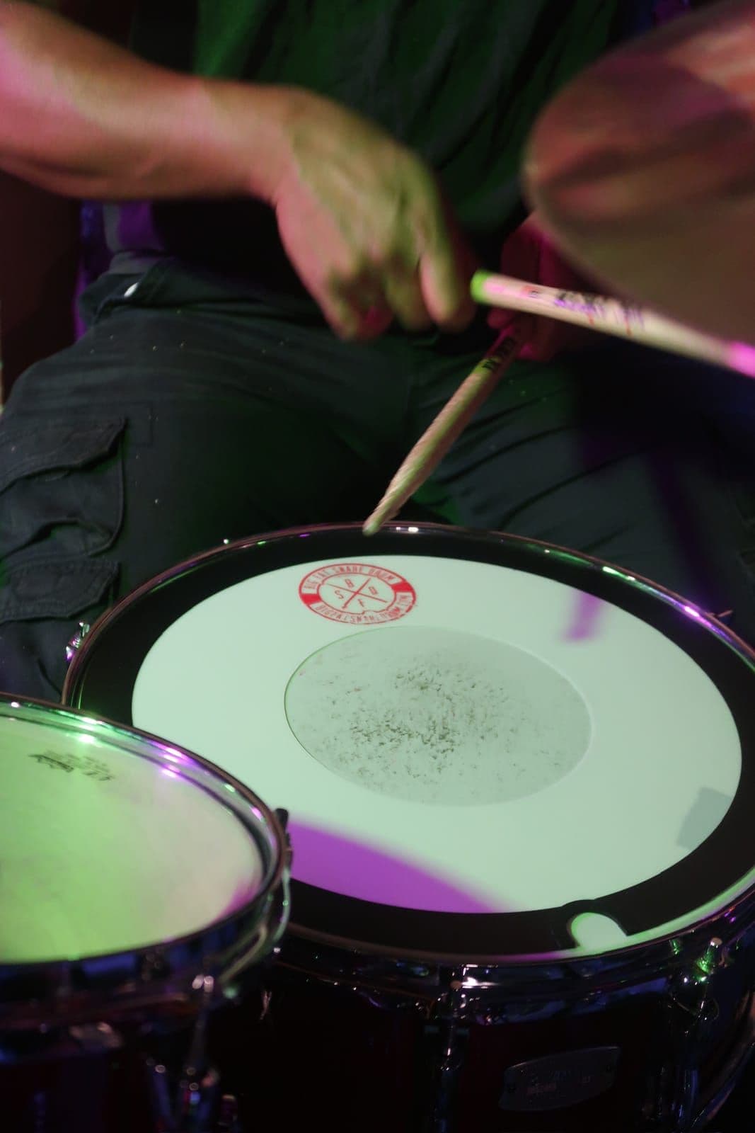 Drummer hitting the snare mid-song